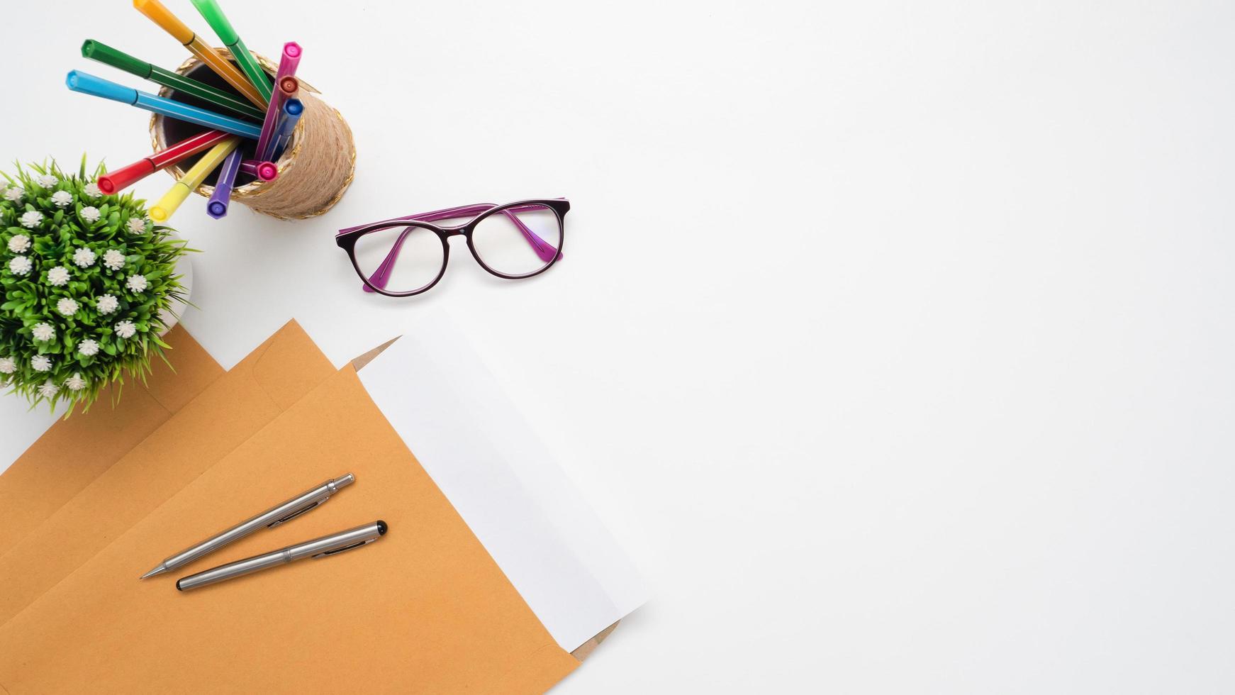 Document with pen and glasses color pen box top view copy space photo