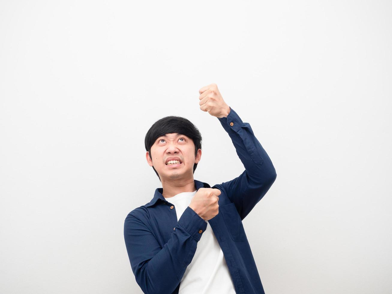 Asian man gesture pull rope down feeling heavy and serious face white background photo