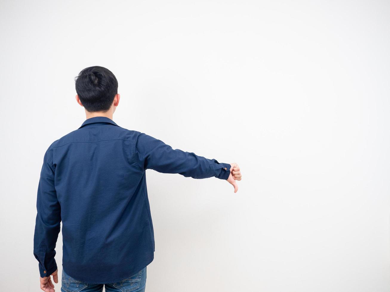 Back view of man jean suit standing show thumb down copy space white background photo