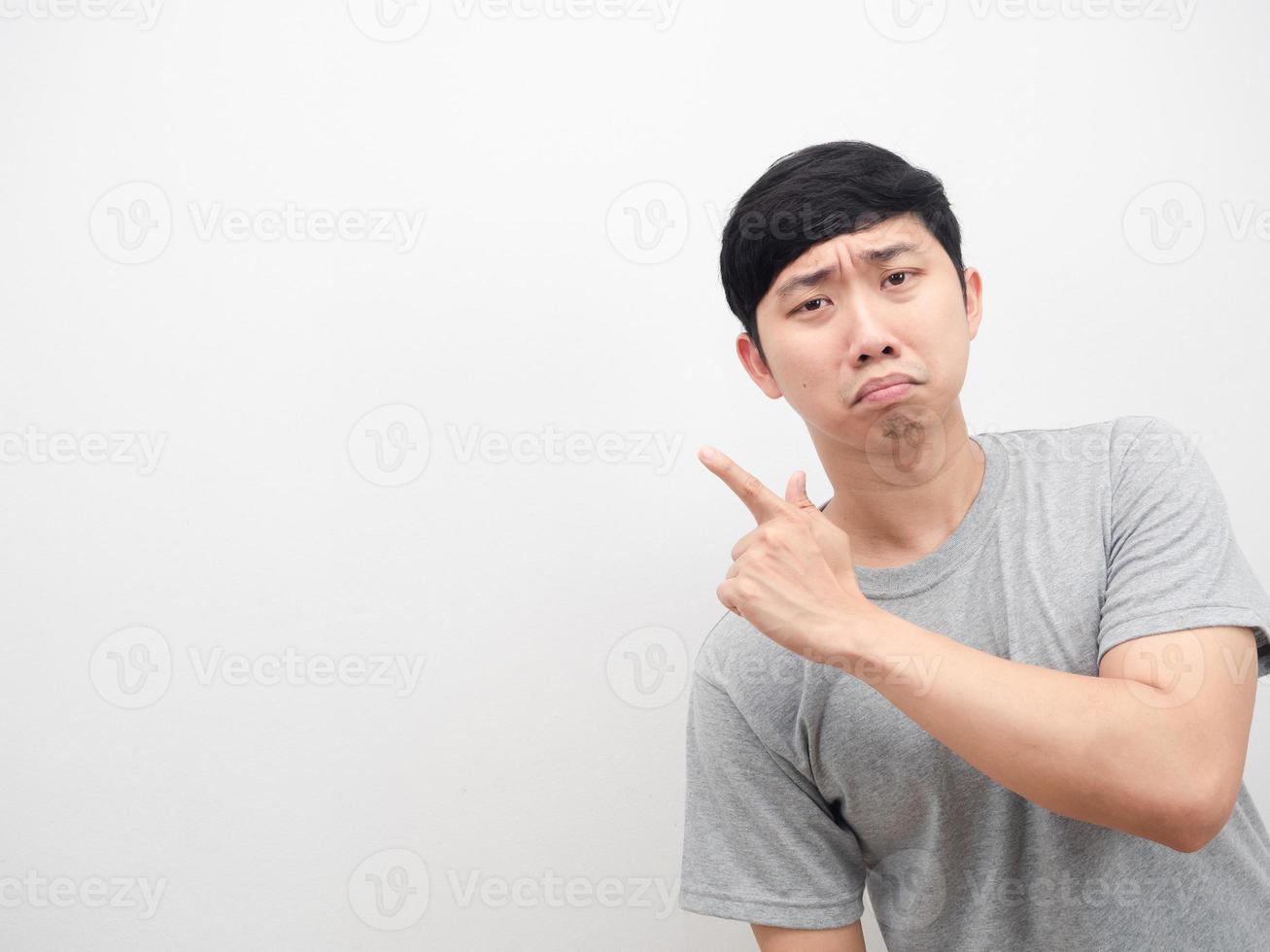 Asian man sad emotion point finger at copy space grey shirt photo