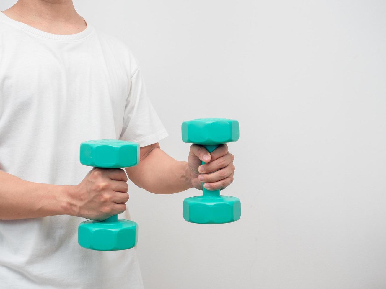 Man holding dumbbell green clolor white background crop shot copy space photo