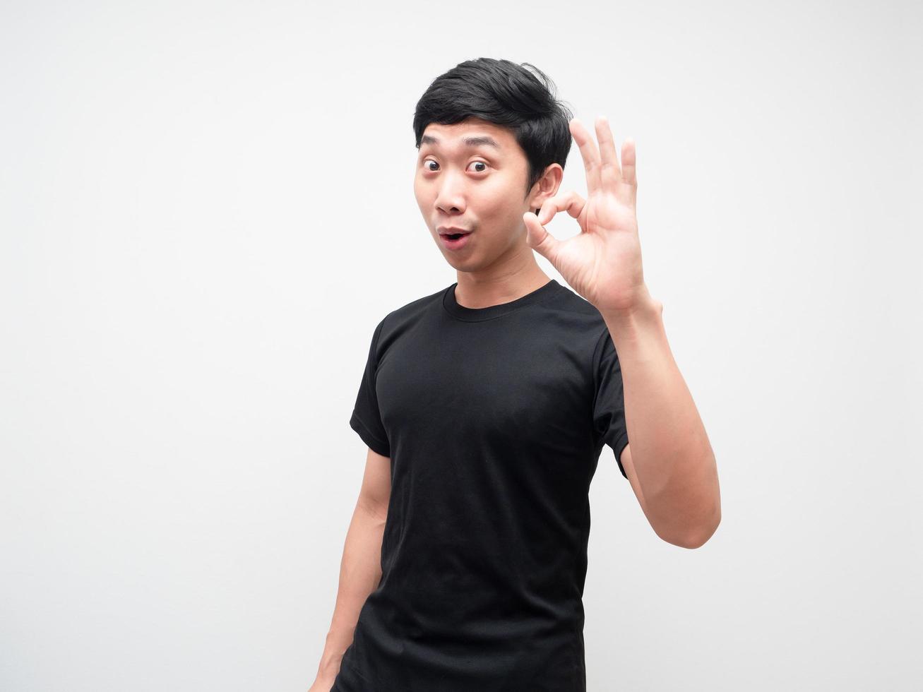 Asian man show hand ok joyful face on white background photo