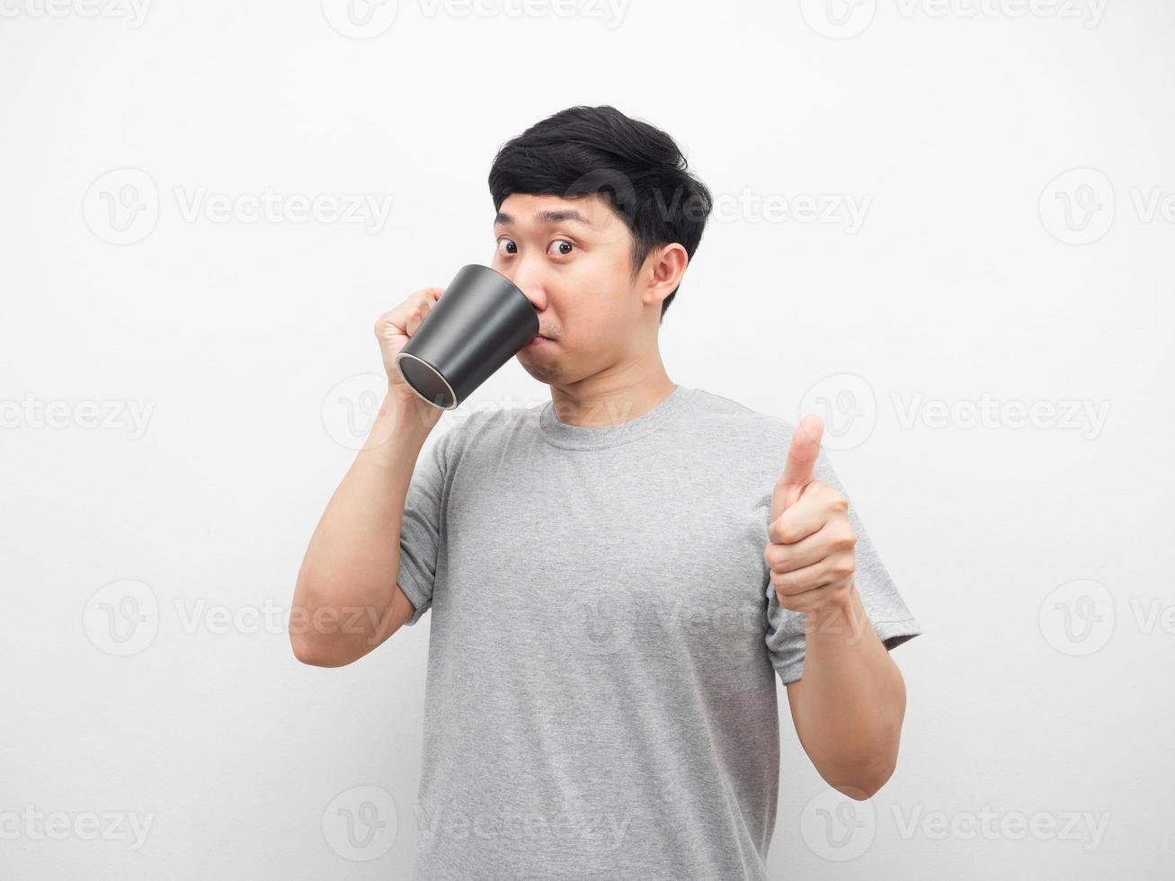 Man grey shirt drinking coffee and thumb up white background photo