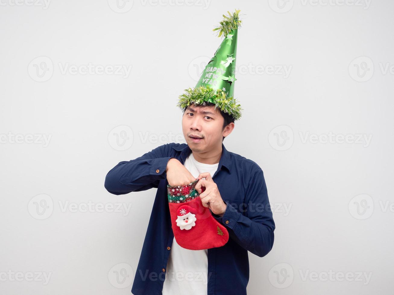 Man push his hand in christmas stocking for find the gift photo