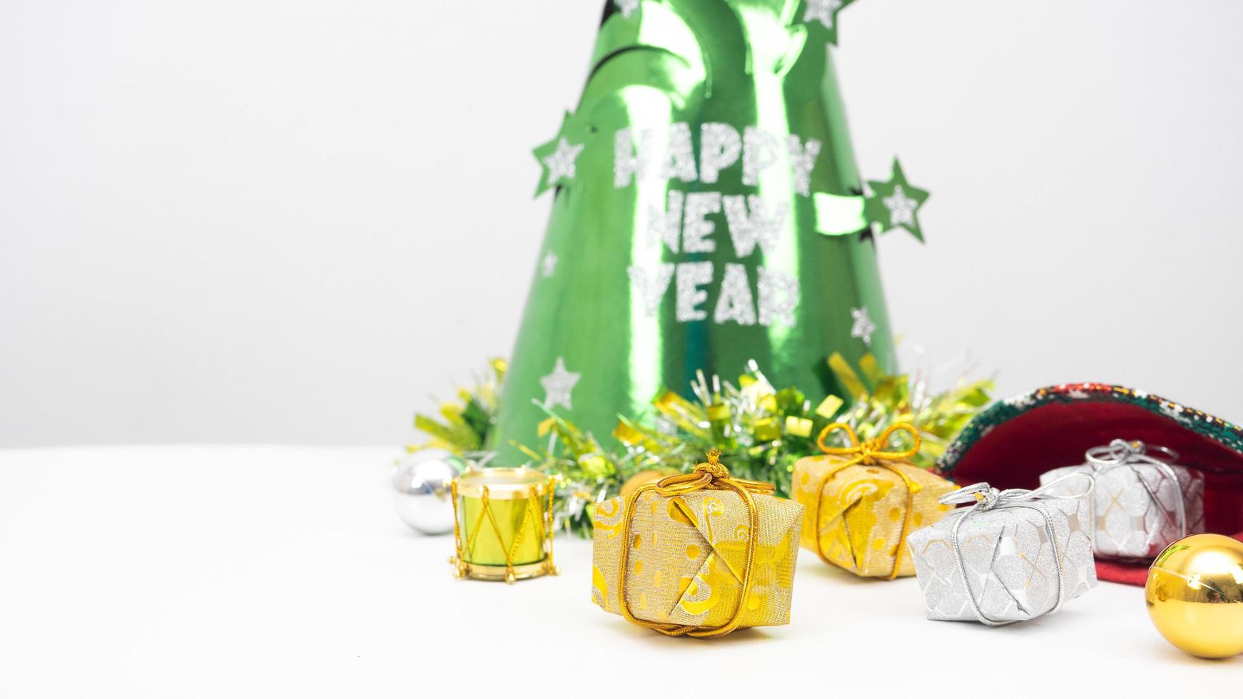 Close up christmas items with green hat happy new year concept on the table white background copy space photo