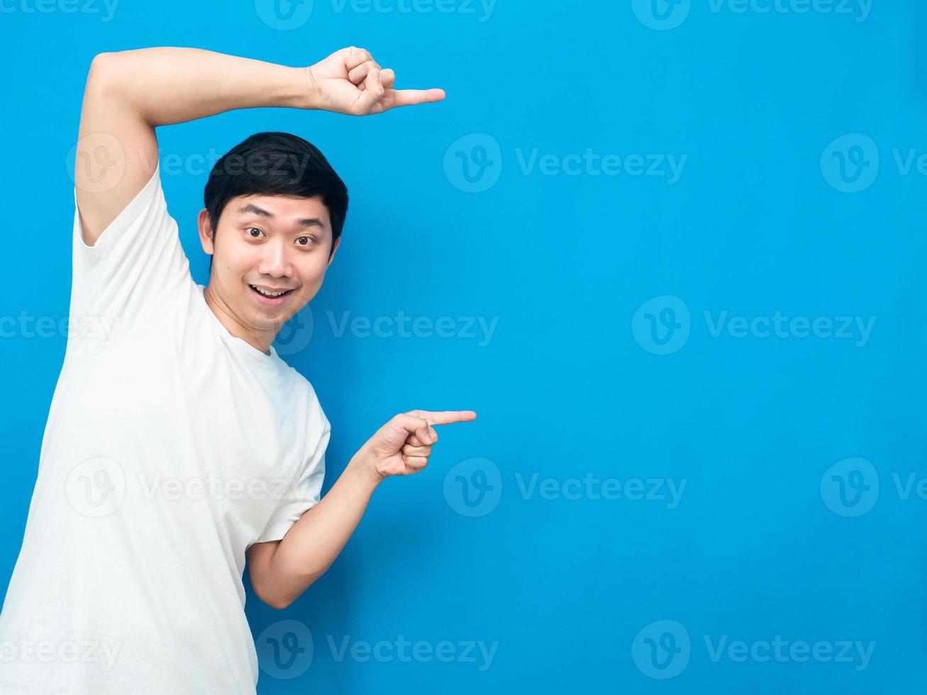 Young man gesture point finger at copy space portrait white background photo