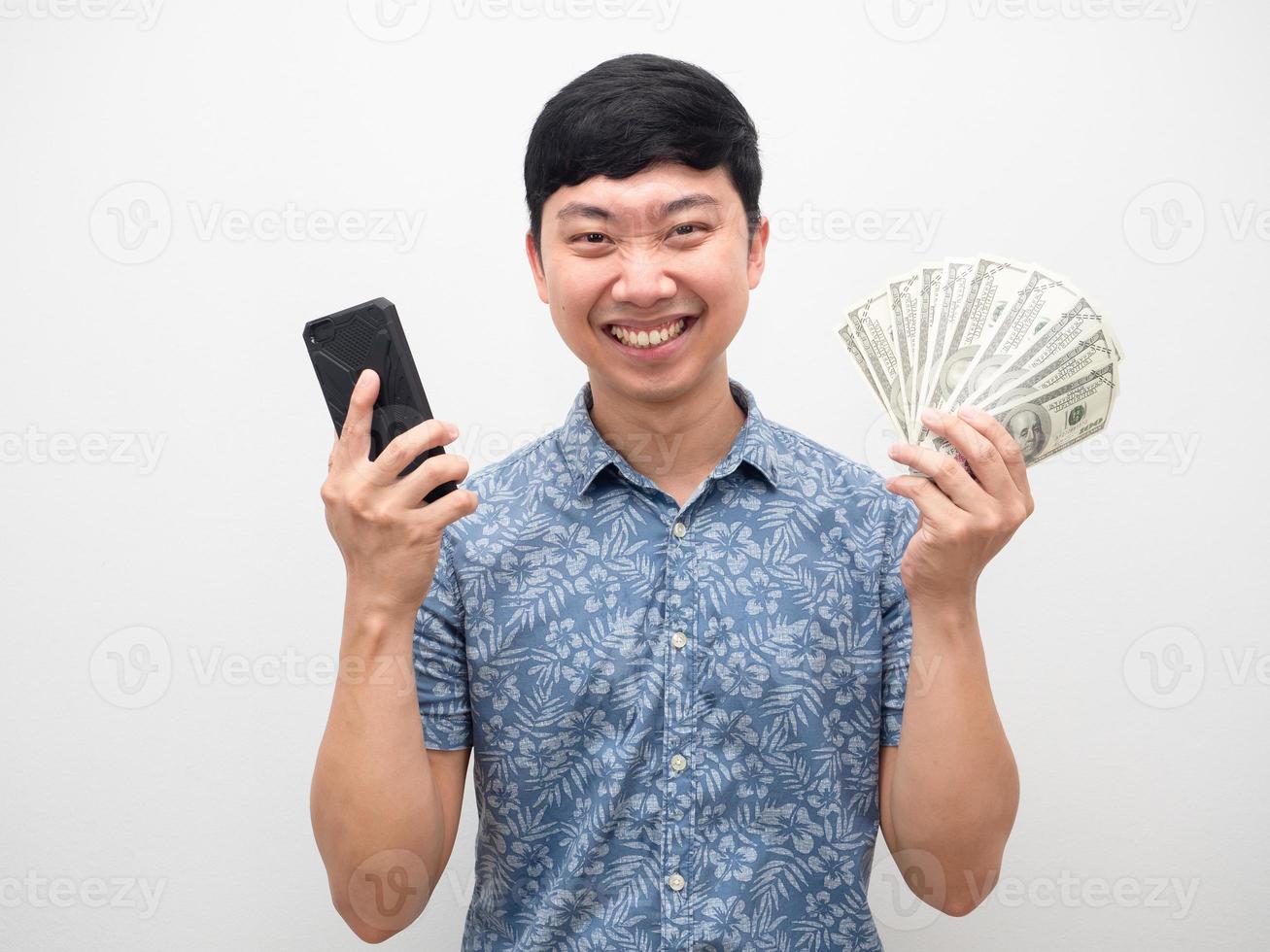 Man cheerful smile with mobile phone and a lot of money in hand photo