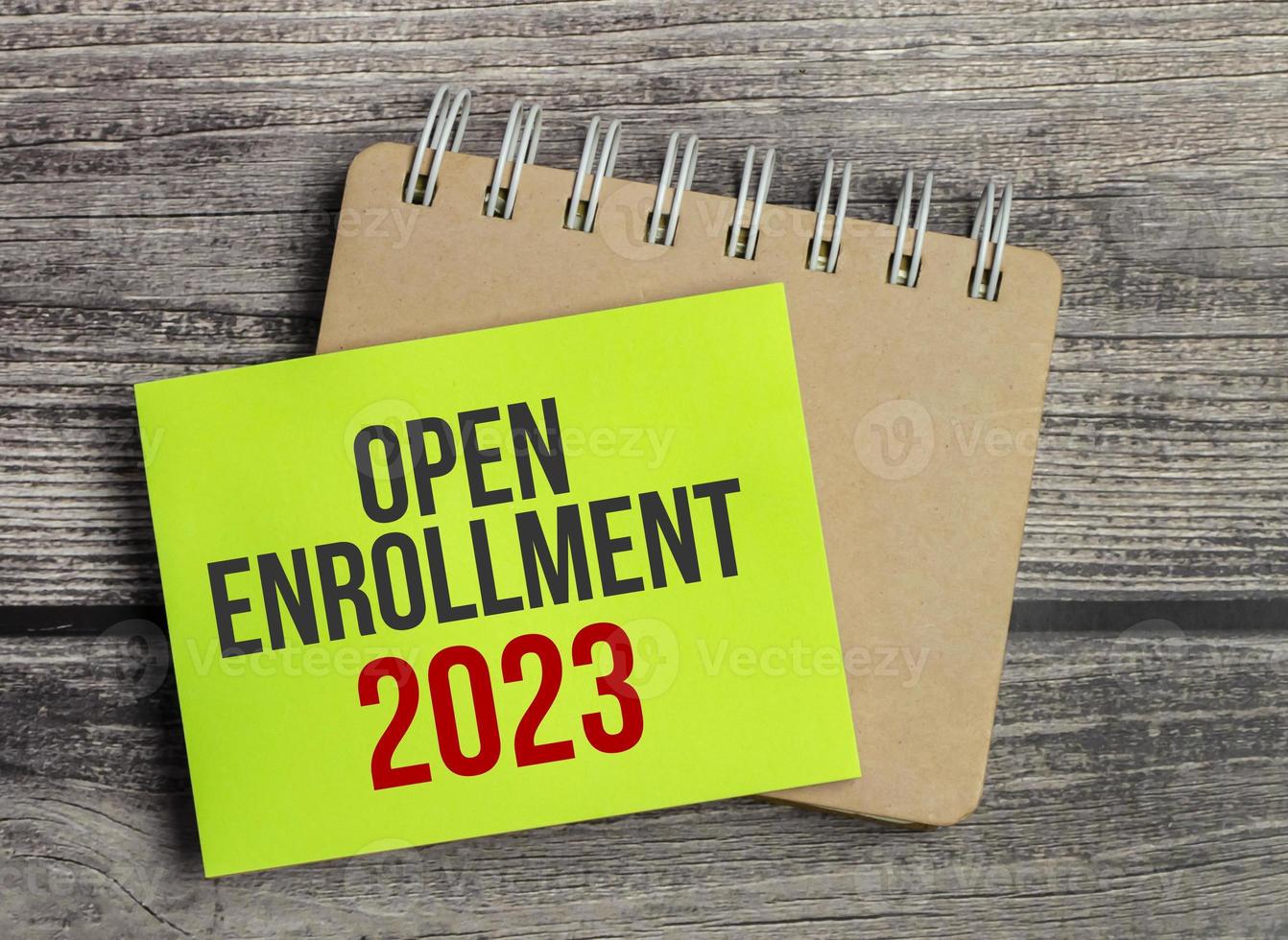 OPEN ENROLLMENT 2023 wording on a green sticker and notepad photo
