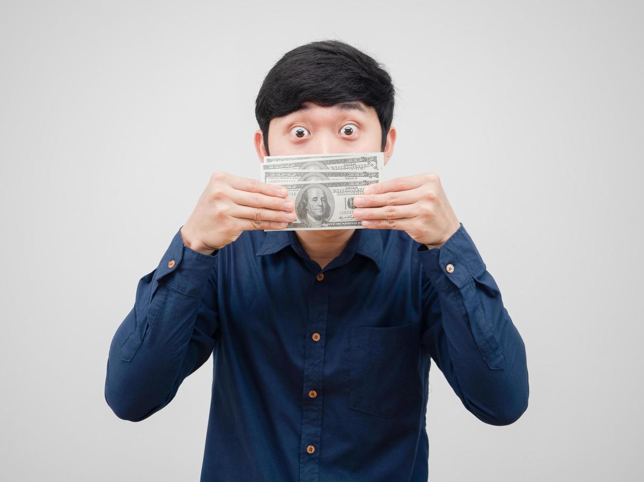 Man cheeful close his face by money dollar lookign at camera white background photo
