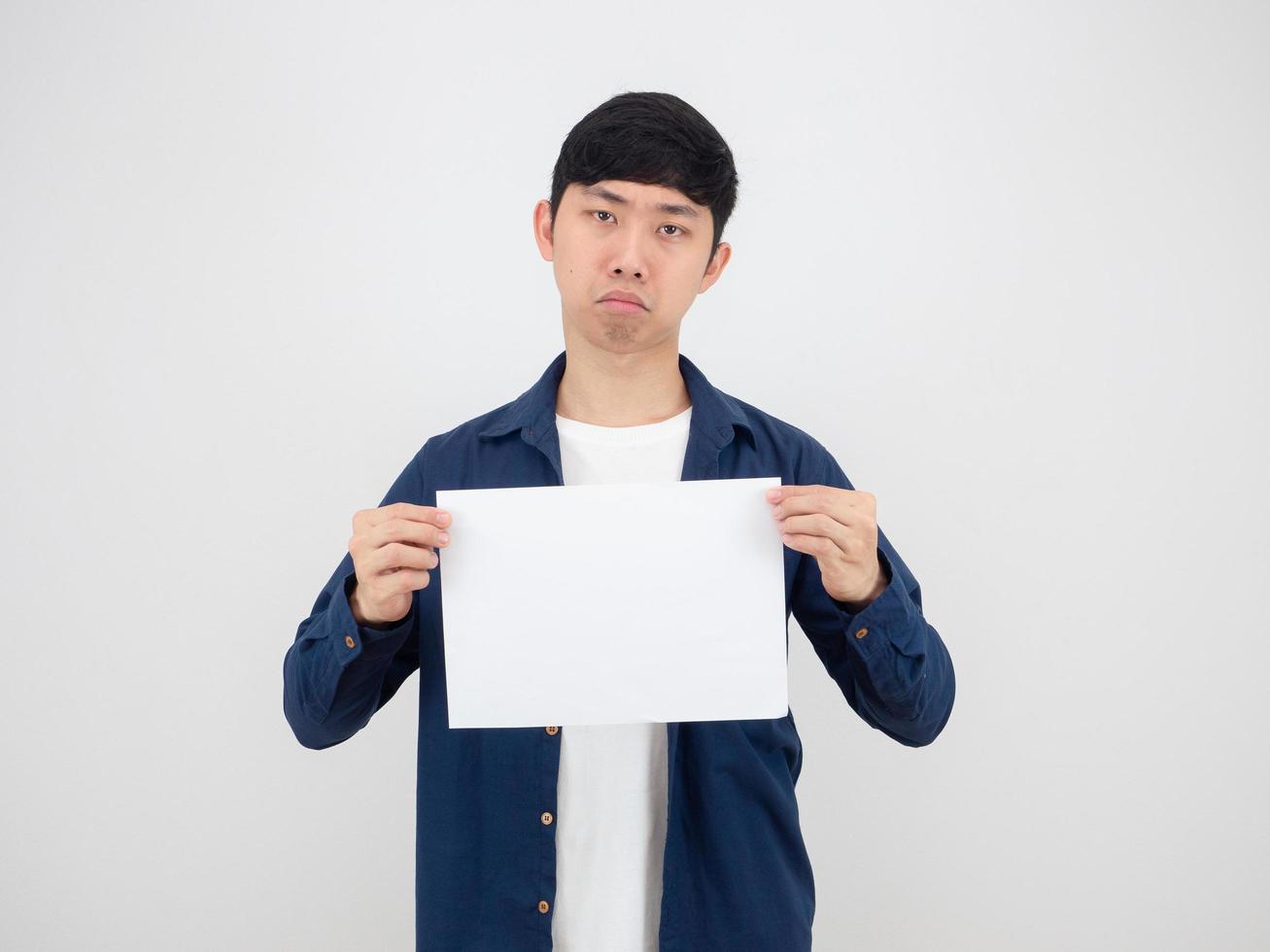 Handsome man holding blank sheet with bored face on white isolated background photo