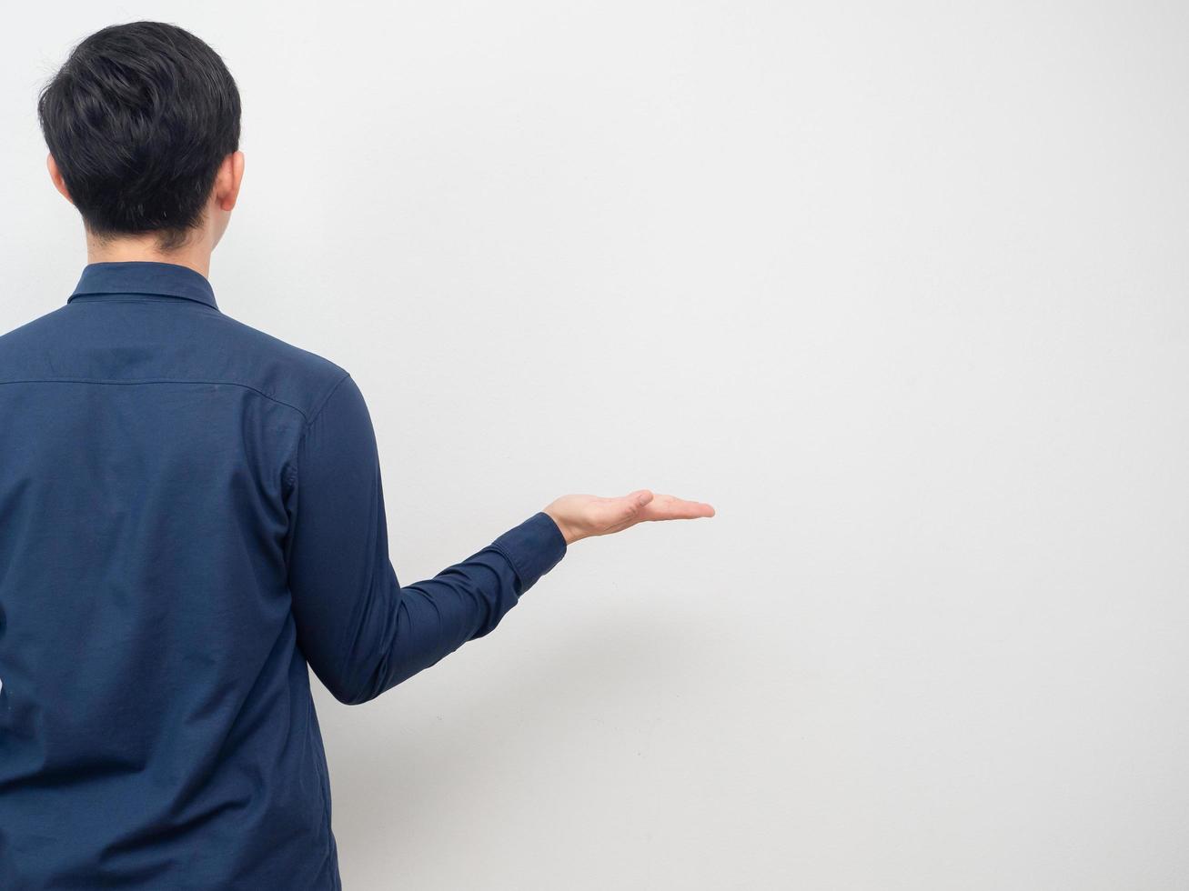 Man turn back show empty hand up for carry product copy space white background photo