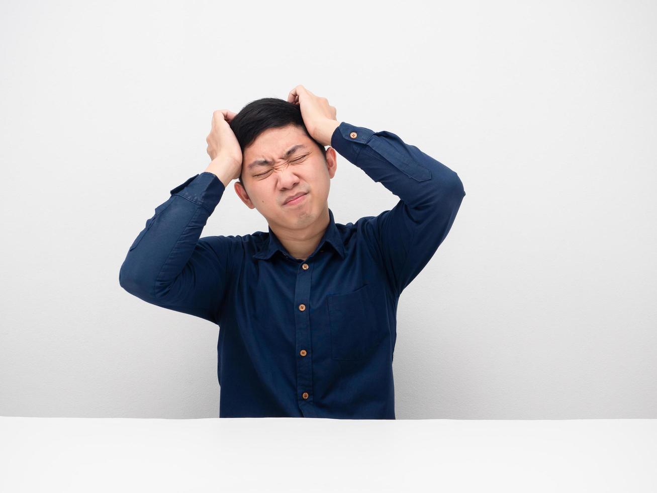 Businessman sitting and feeling headache about working photo