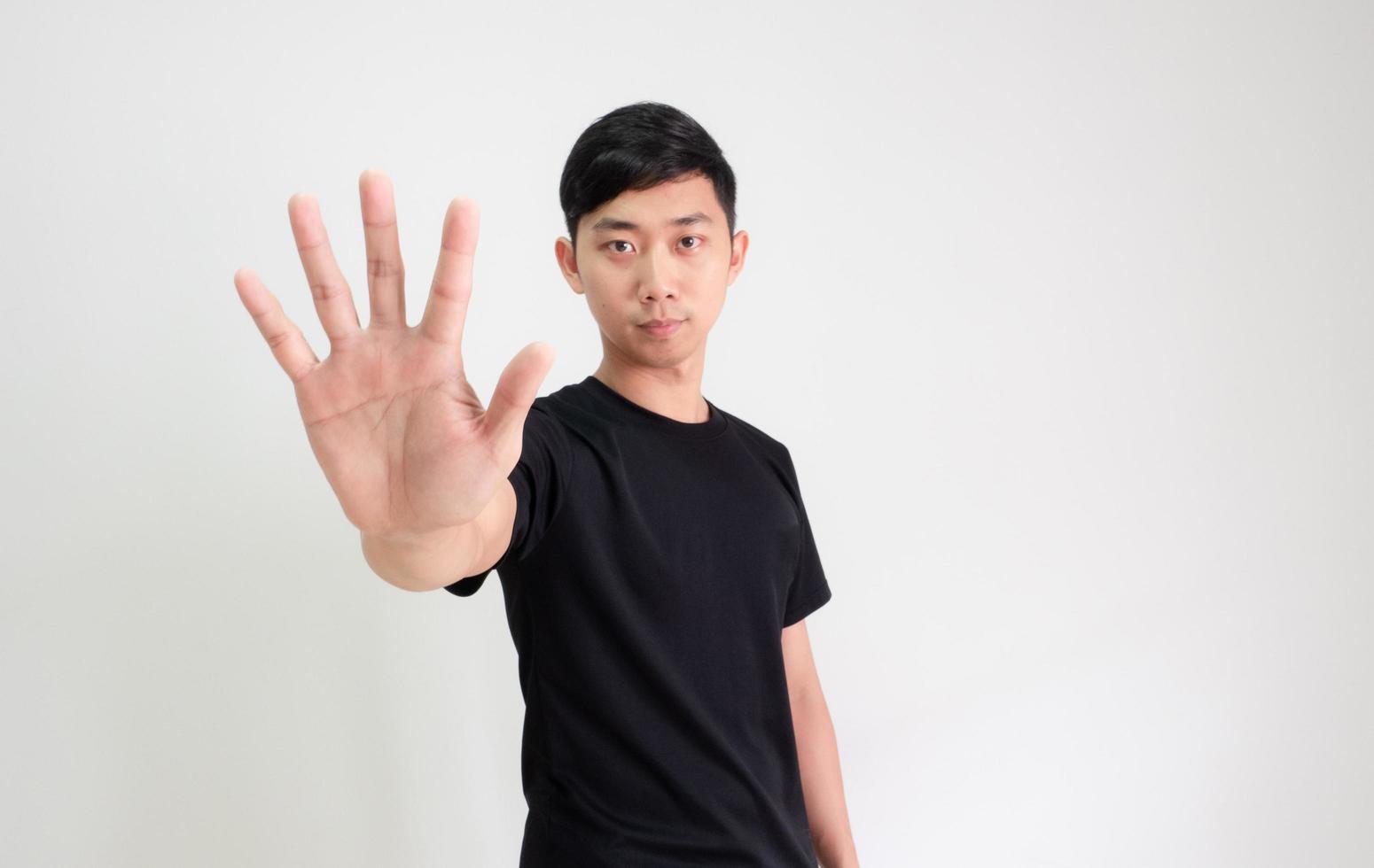 Young Asian man black shirt count one to ten by hand half body on white isolated background,Man counting number concept photo