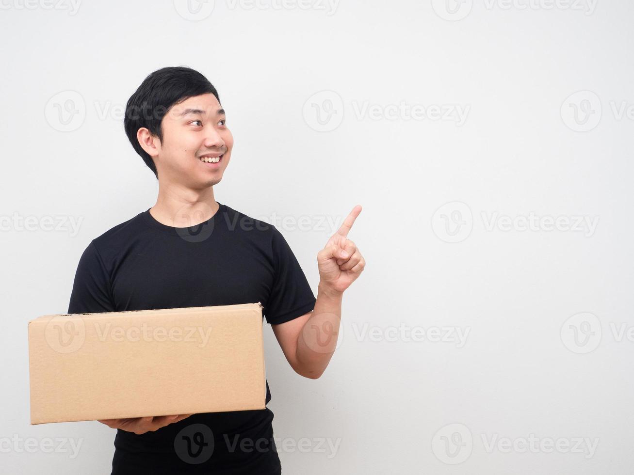 Man holding shopping box and point finger at copy space photo