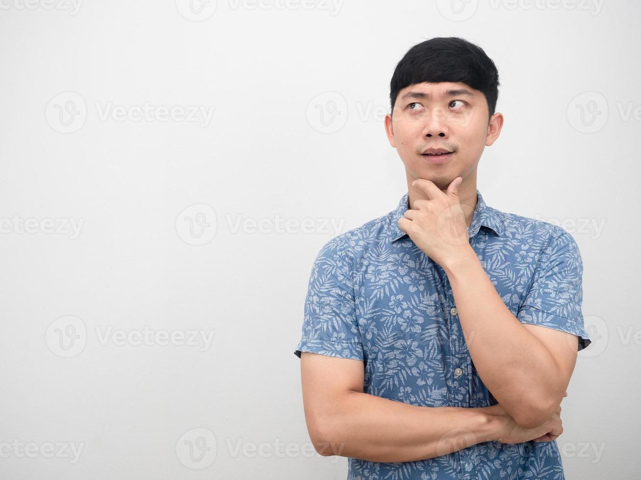 Portrait asian man blue shirt gesture thinking and looking at copy space photo