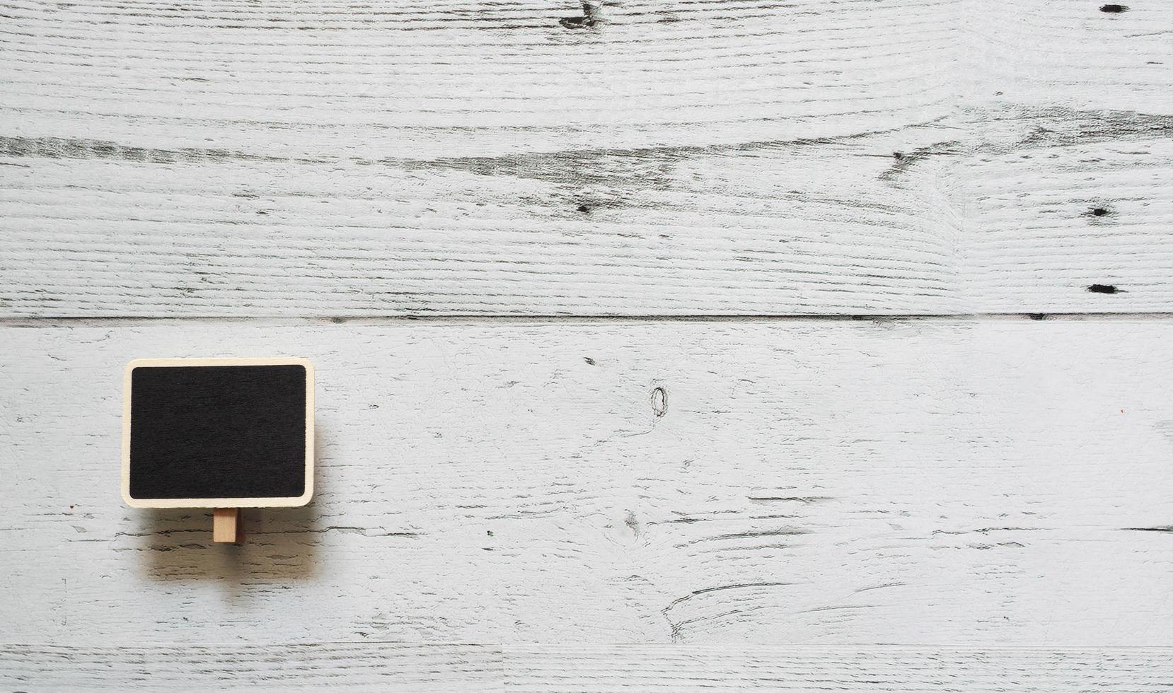 Small chalkboard clip array line on white wood table top view nature shadow space,Idea notice chalkboard concept photo