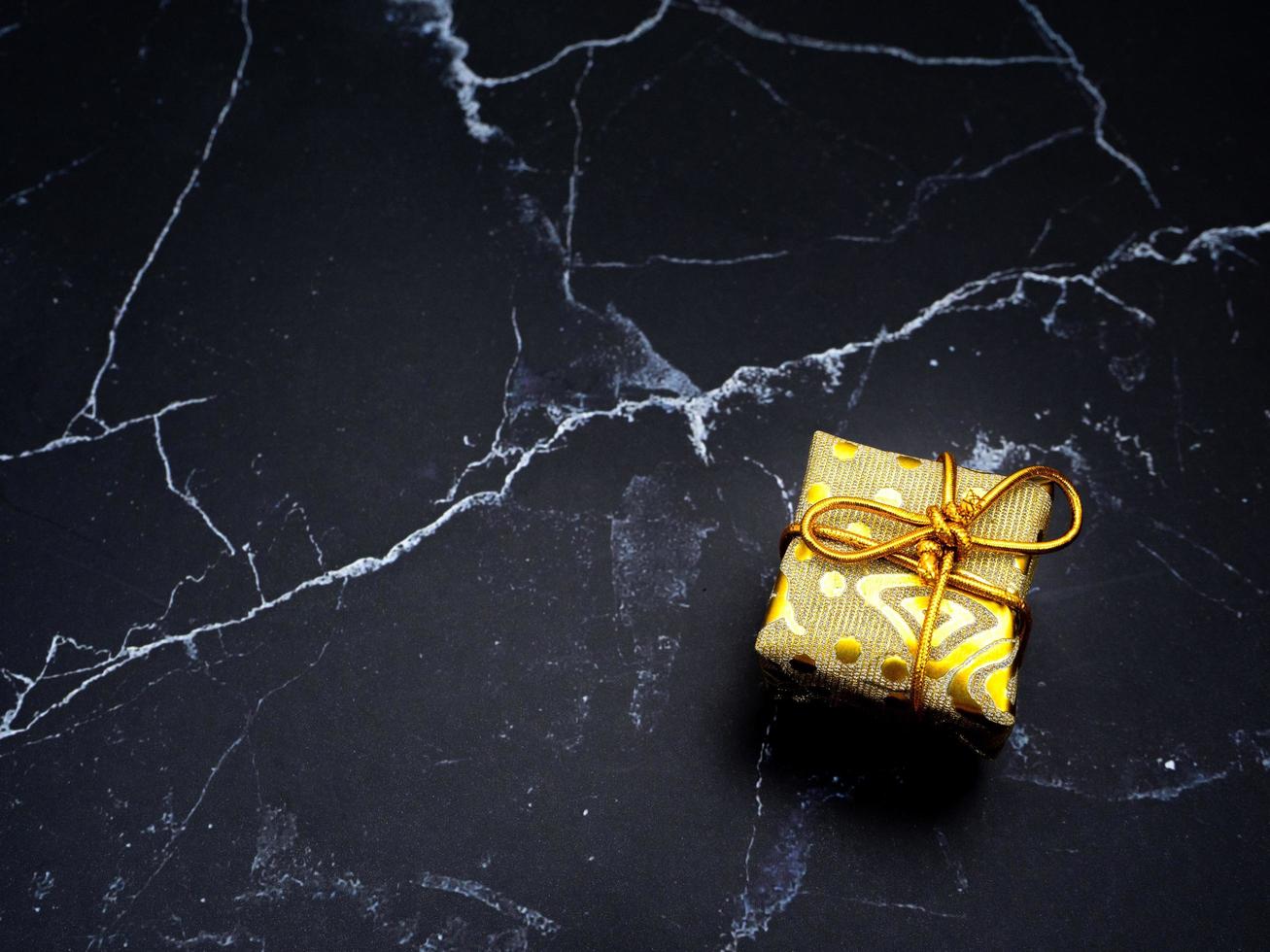 Close up gift box on black marble top view copy space photo