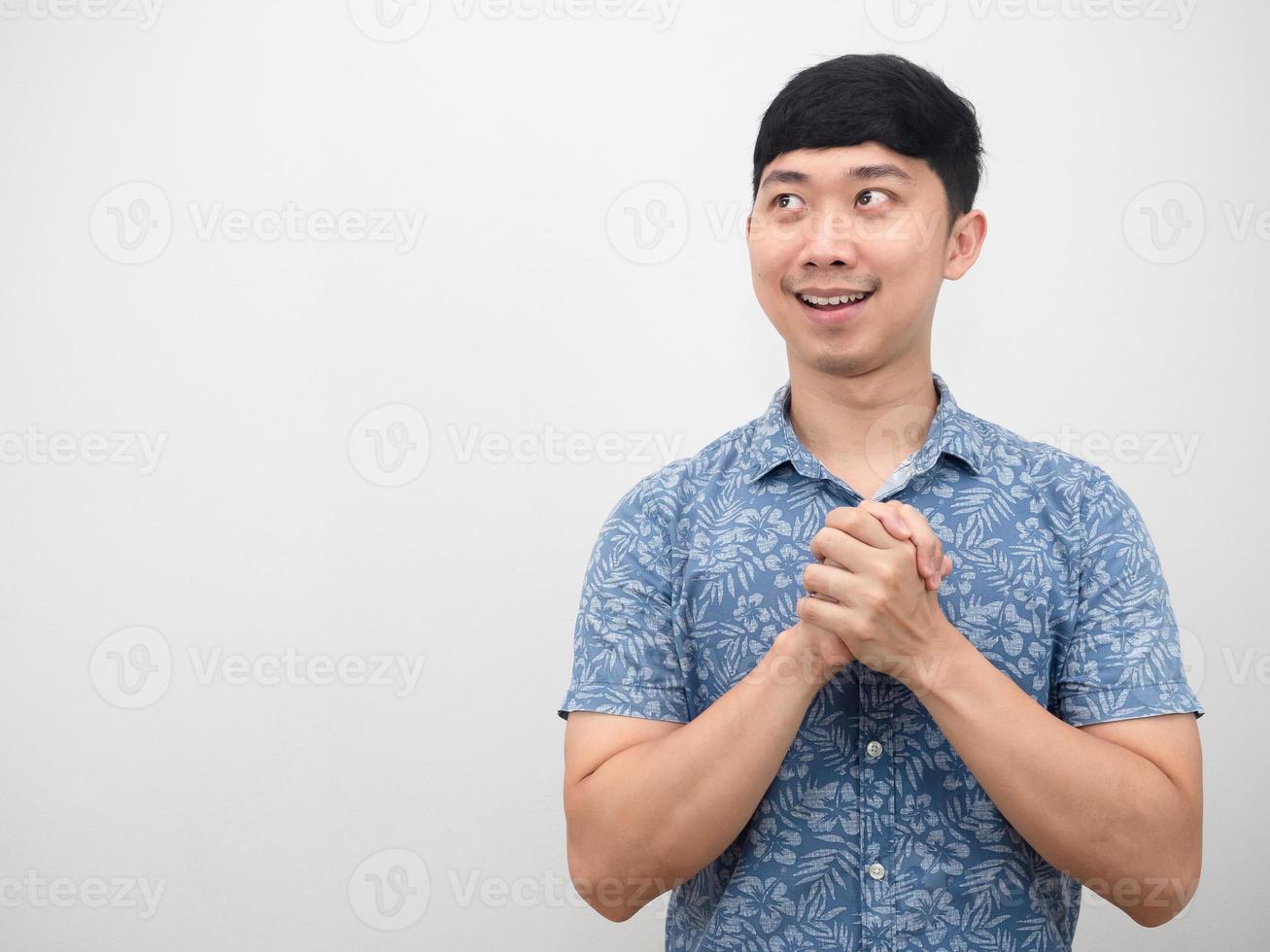 Asian man blue shirt joy hand and hopeful looking at copy space photo