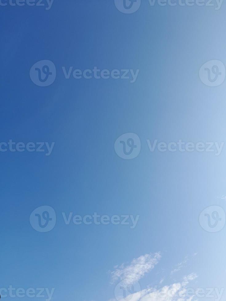 White clouds in the blue sky. Heaven and infinity. Beautiful bright blue background. Light cloudy, good weather. Curly clouds on a sunny day. photo