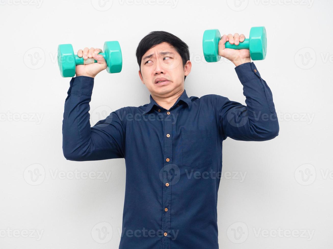 Man holding dumbbell feeling heavy photo