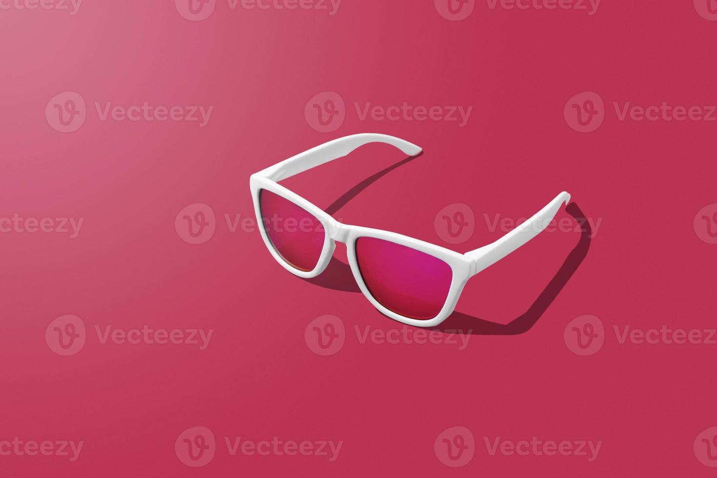 White sunglasses on magenta background with hard light scene and copy space. Studio shot of modern sunglasses on Viva Magenta tones background. photo