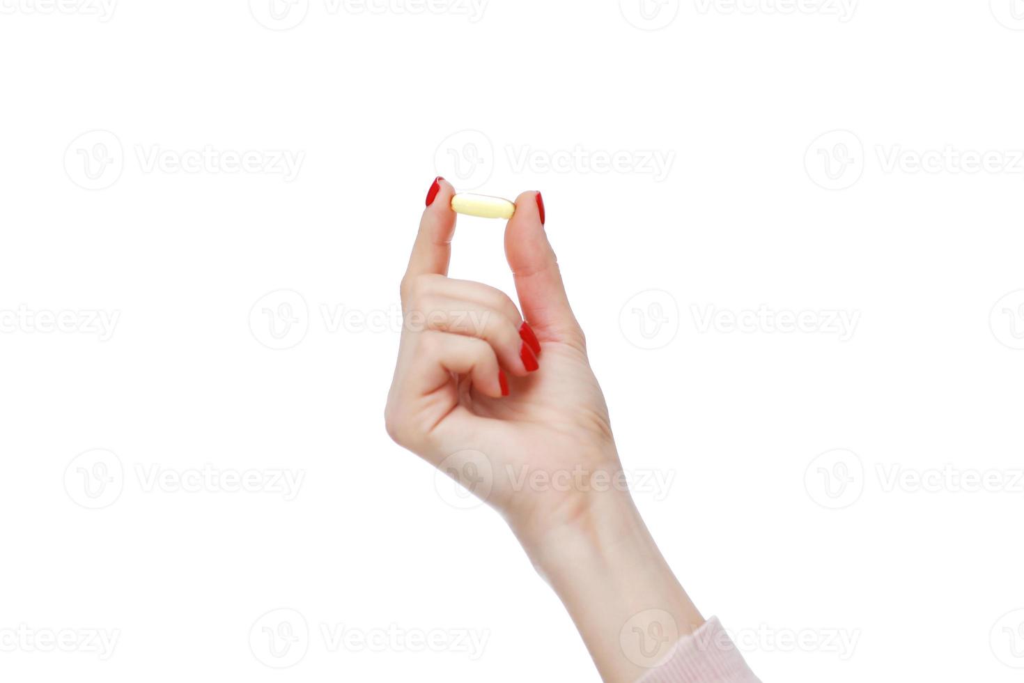 Hand holding capsule of Omega 3 on white background. Close up. High resolution product. Health care concept photo