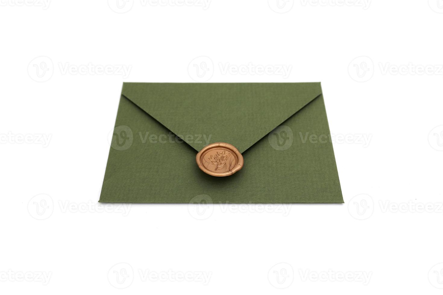 green envelope with designer cardboard and seal on a white background. Envelope with seal photo