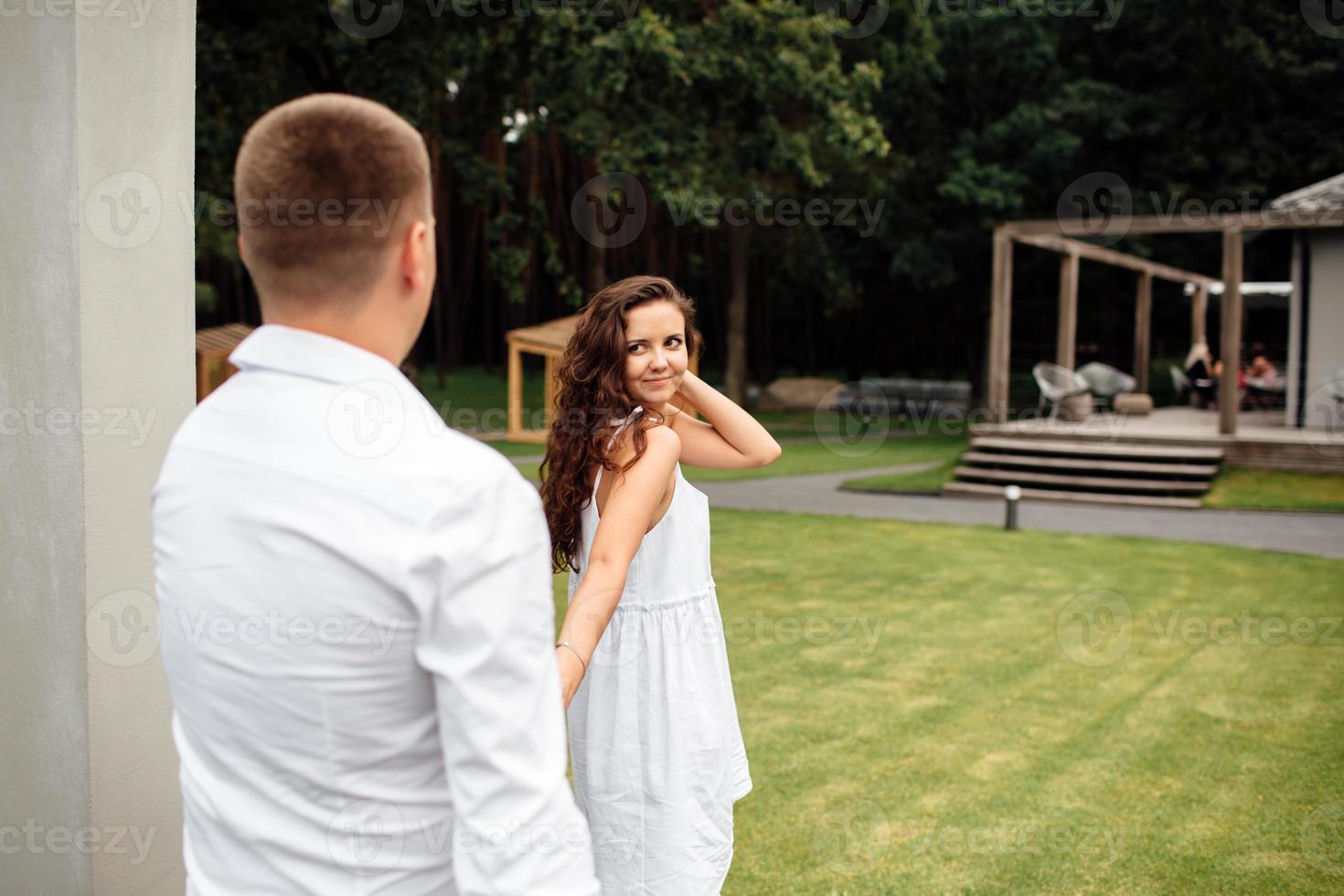 Portrait of cheerful woman and man spending time together outdoors, kissing, hugging and laughing in summer park, couple in love on valentine's day togetherness. valentines day. photo