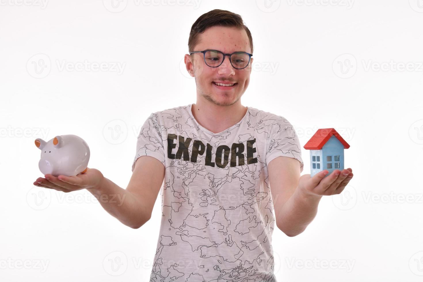 Man holding a piggy bank and a house model. Housing industry mortgage plan and residential tax saving strategy photo