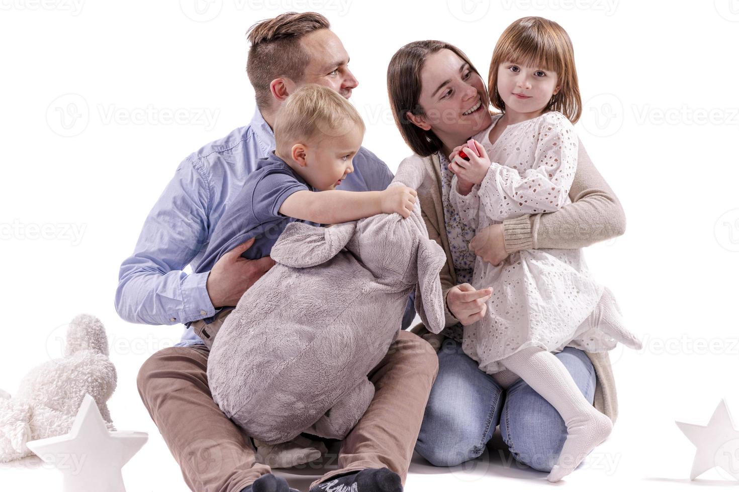 Happy to be a family. Happy family of four bonding to each other and smiling photo