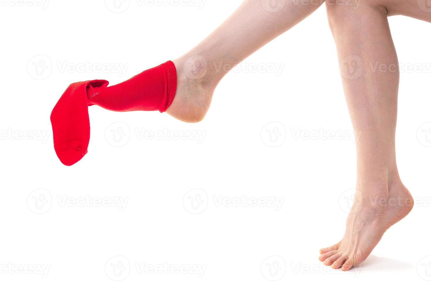 Girl putting on stockings at home. Beautiful female legs. photo