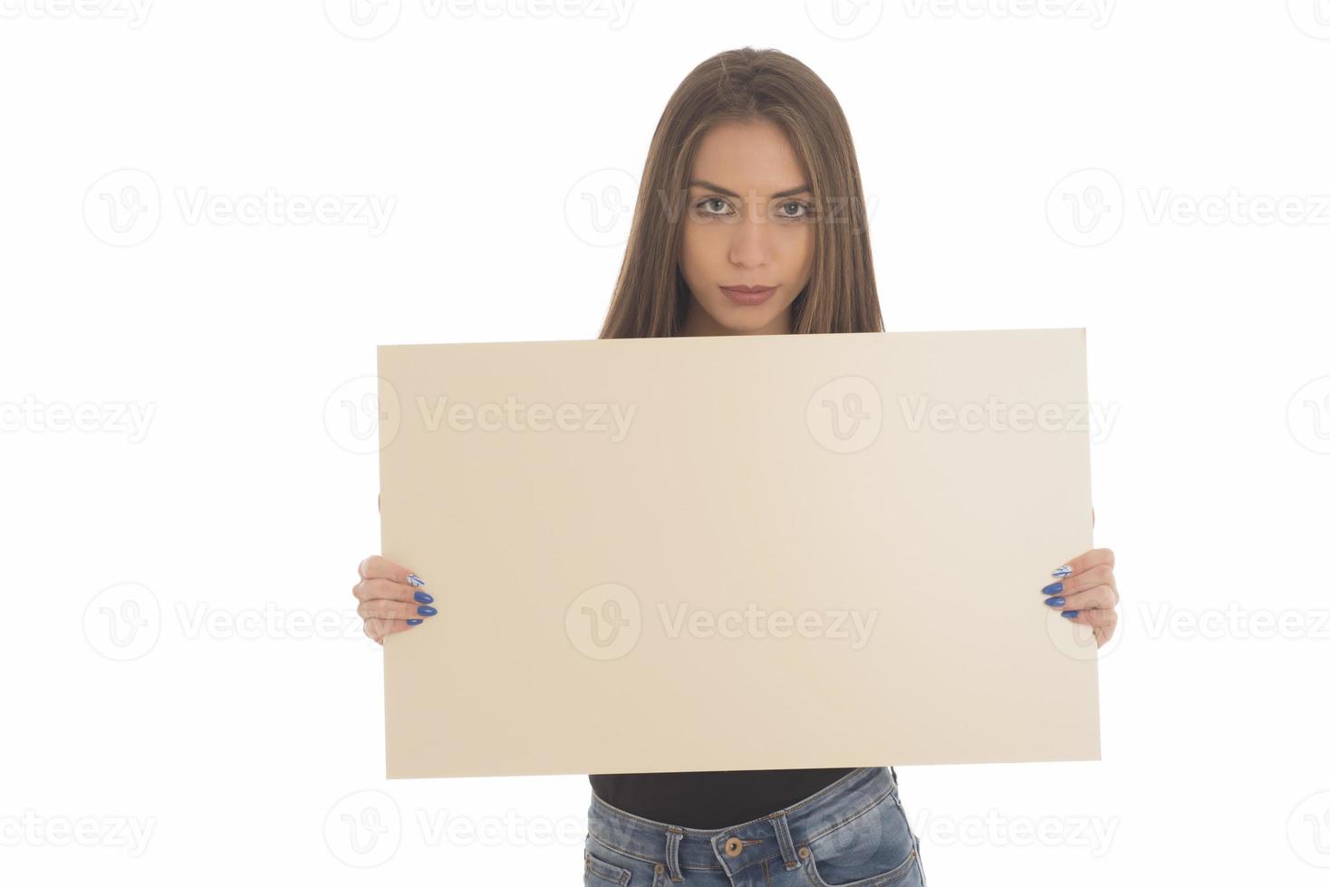 smiling girl holding blank sign board. studio portrait of young woman with sign card. isolated. photo
