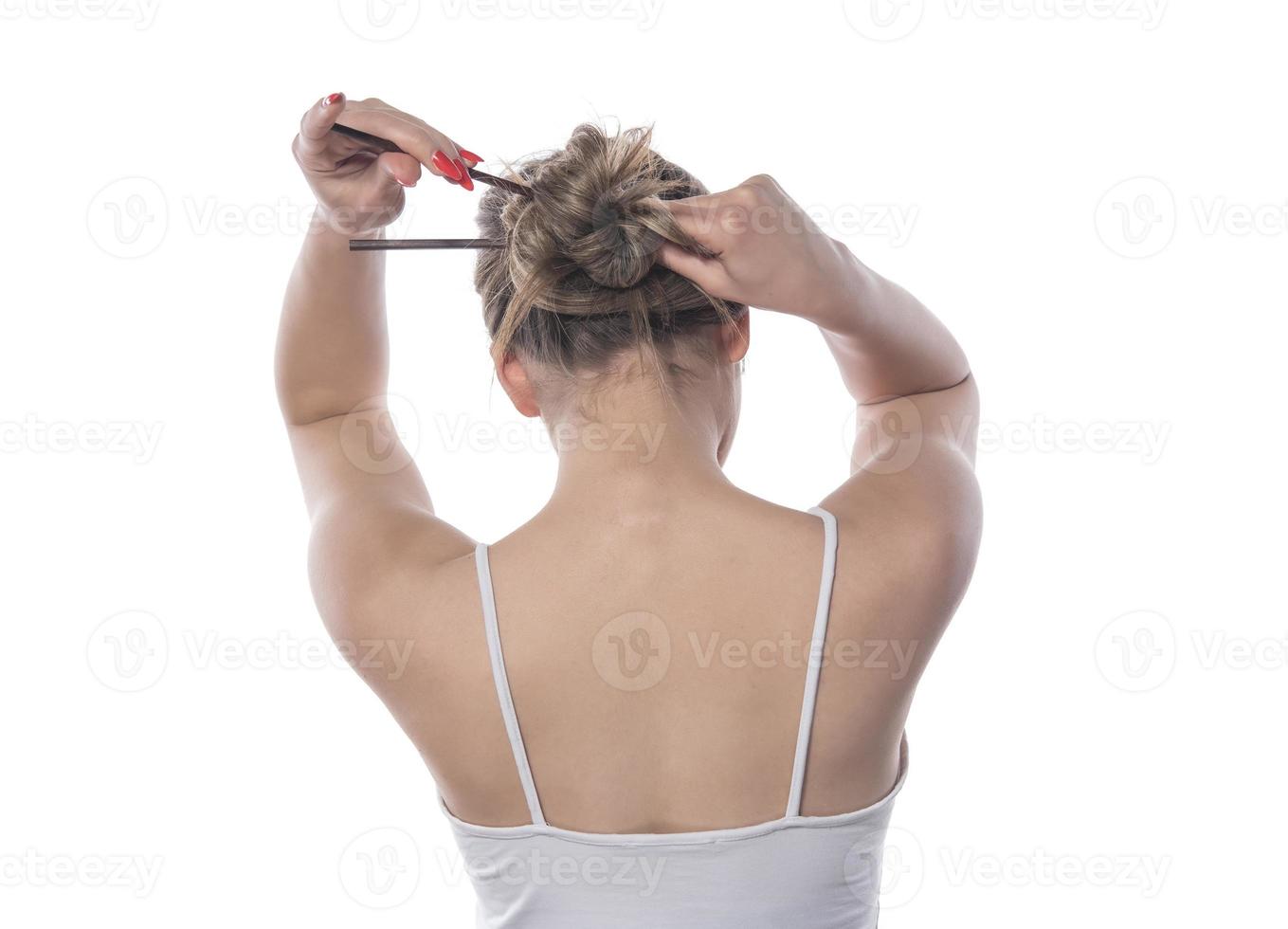 A young beautiful woman tied her hair with a rubber band photo