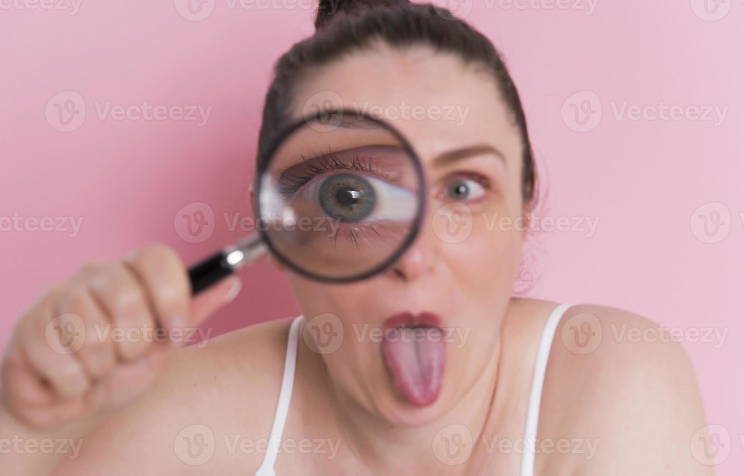 woman looking true magnifying glass photo