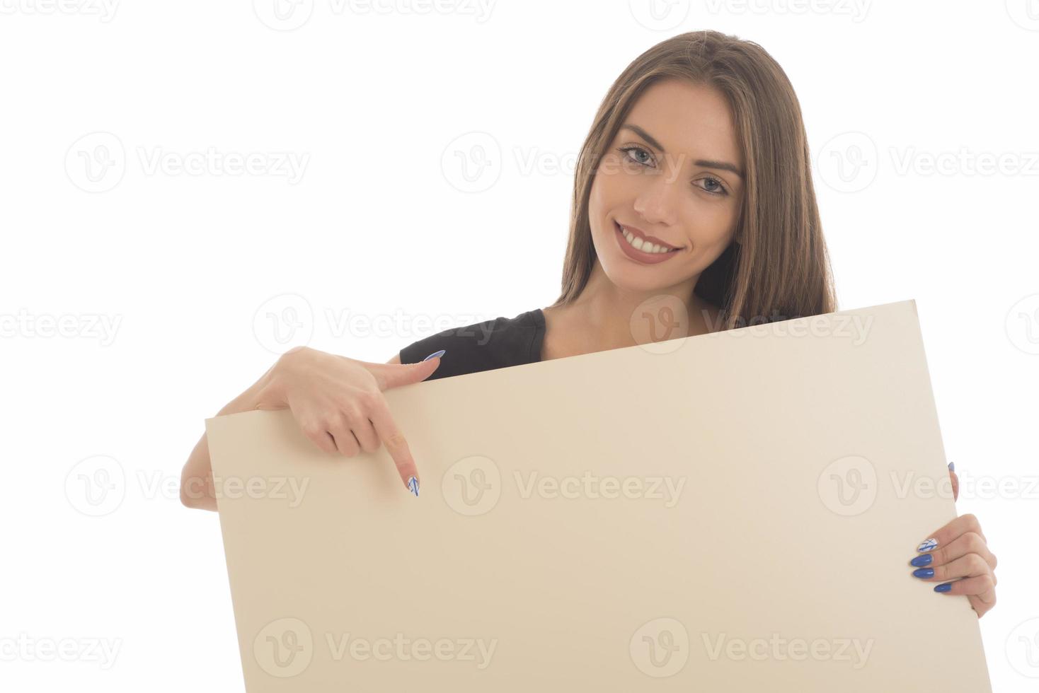 smiling girl holding blank sign board. studio portrait of young woman with sign card. isolated. photo