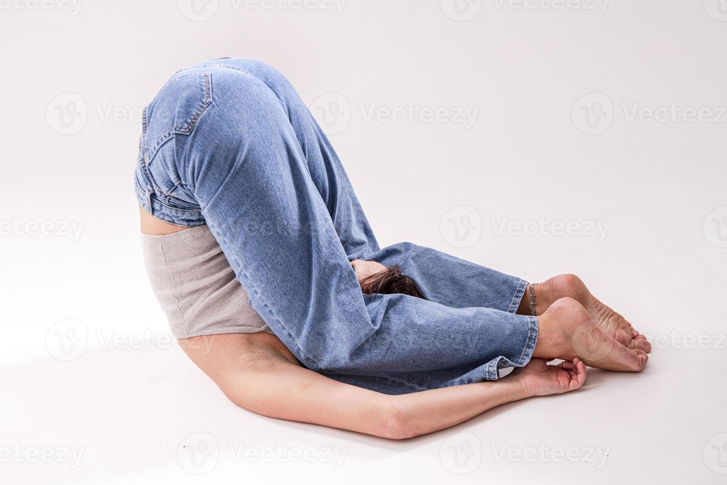 Portrait of beautiful young woman with athletic flexible body doing leg stretching. isolated photo