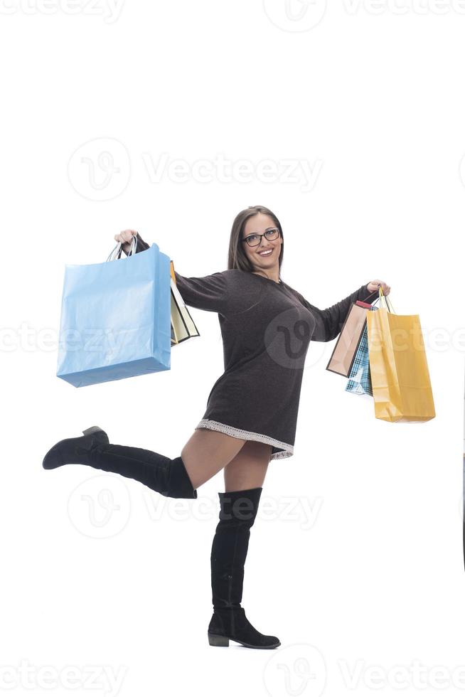 Happy woman full body portrait with shopping bag on isolated studio background. photo