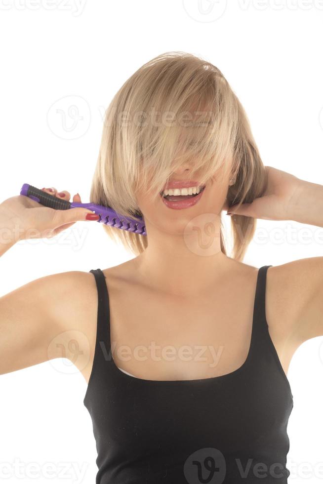 Closeup on young woman combing hair photo