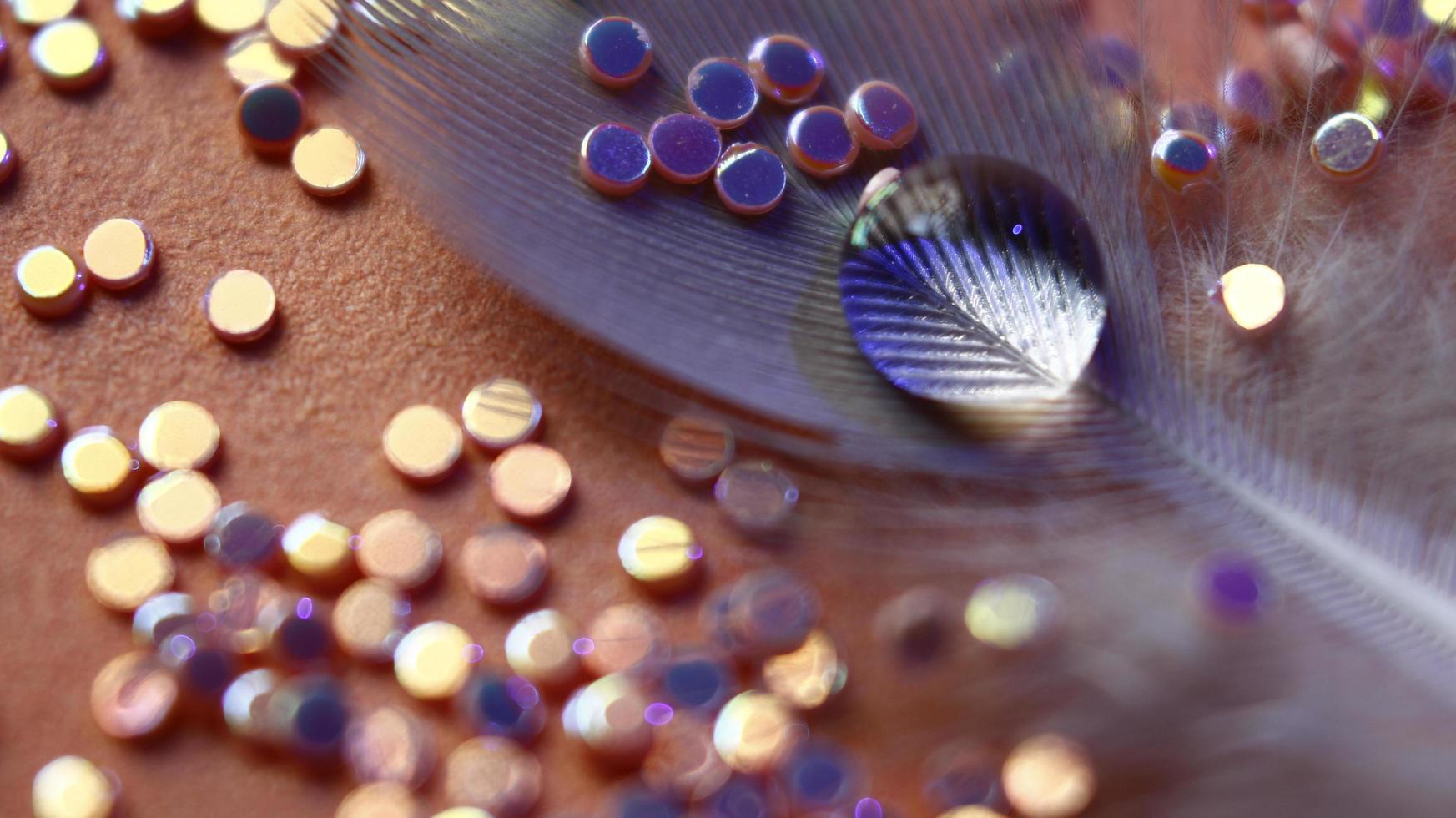 Close-up Of water drop with glitter on it in different colorful loghts in Karachi Pakistan 2022 photo