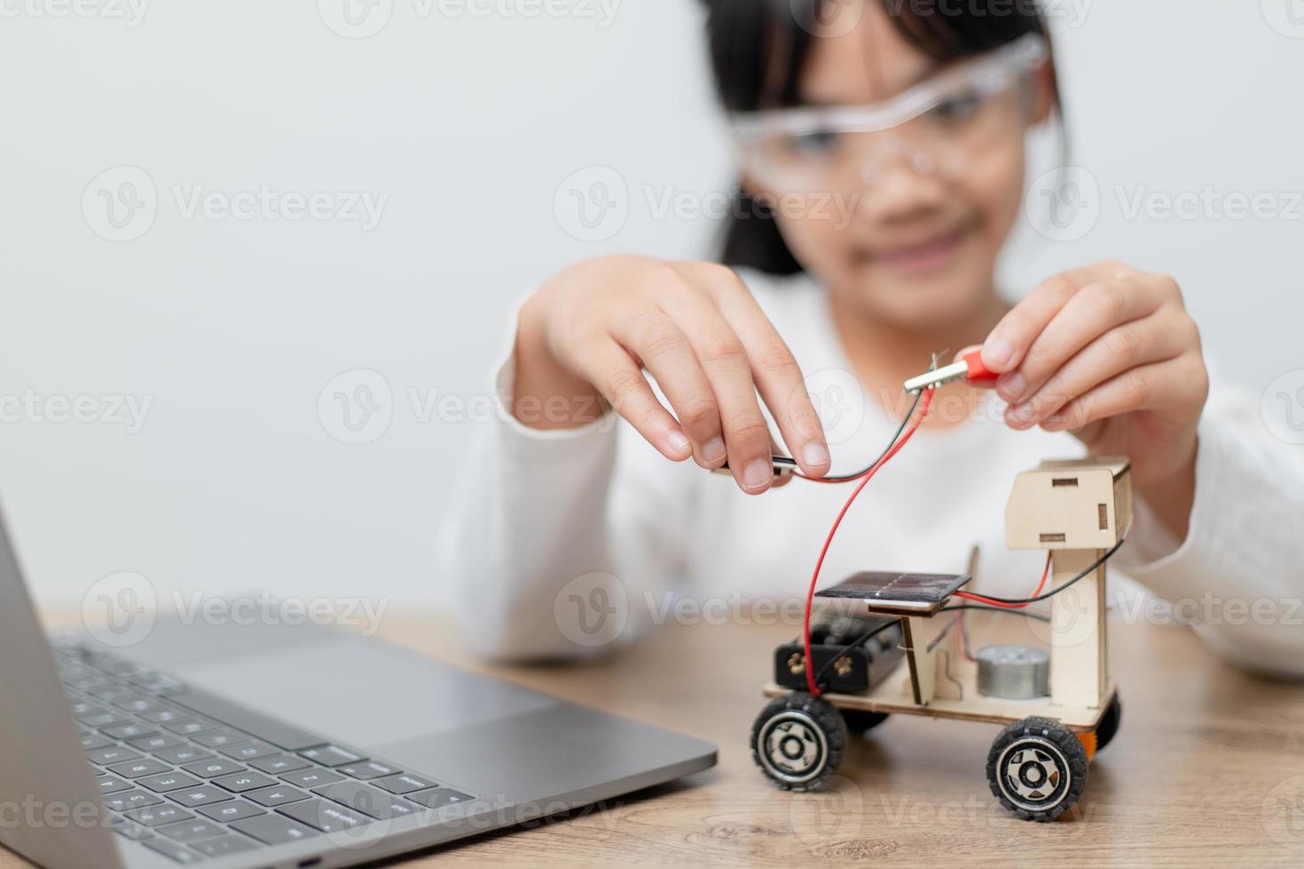 Asia students learn at home in coding robot cars and electronic board cables in STEM, STEAM, mathematics engineering science technology computer code in robotics for kids concept. photo