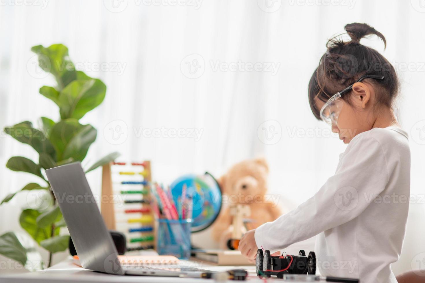 Asia students learn at home in coding robot cars and electronic board cables in STEM, STEAM, mathematics engineering science technology computer code in robotics for kids concept. photo