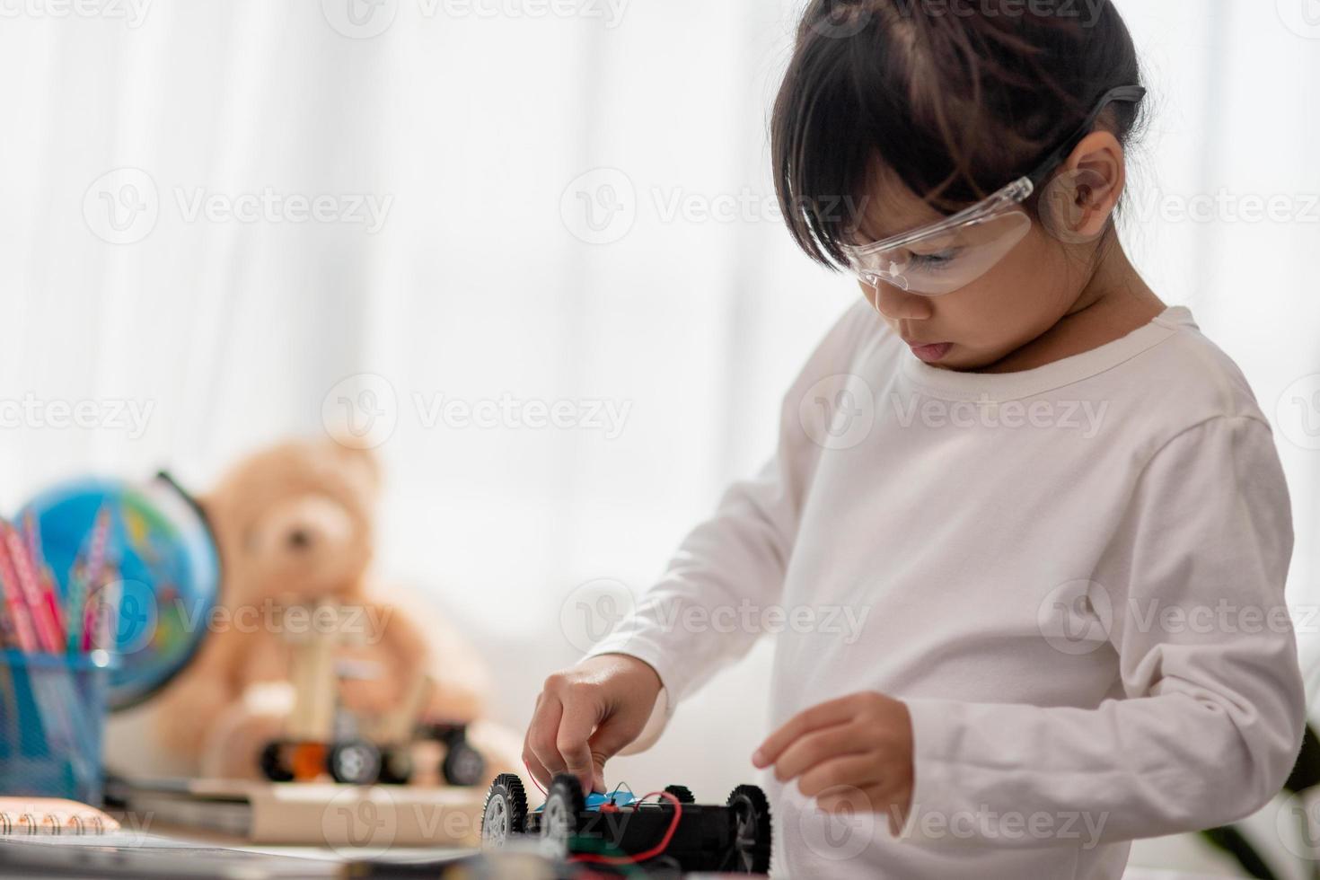 Asia students learn at home in coding robot cars and electronic board cables in STEM, STEAM, mathematics engineering science technology computer code in robotics for kids concept. photo