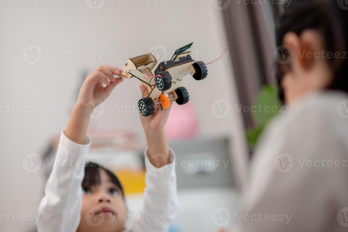Asia students learn at home in coding robot cars and electronic board cables in STEM, STEAM, mathematics engineering science technology computer code in robotics for kids concept. photo