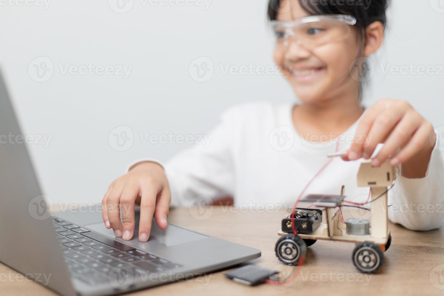 Asia students learn at home in coding robot cars and electronic board cables in STEM, STEAM, mathematics engineering science technology computer code in robotics for kids concept. photo