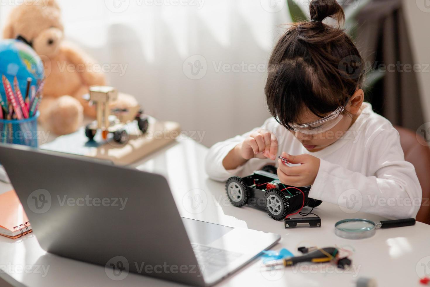 Asia students learn at home in coding robot cars and electronic board cables in STEM, STEAM, mathematics engineering science technology computer code in robotics for kids concept. photo