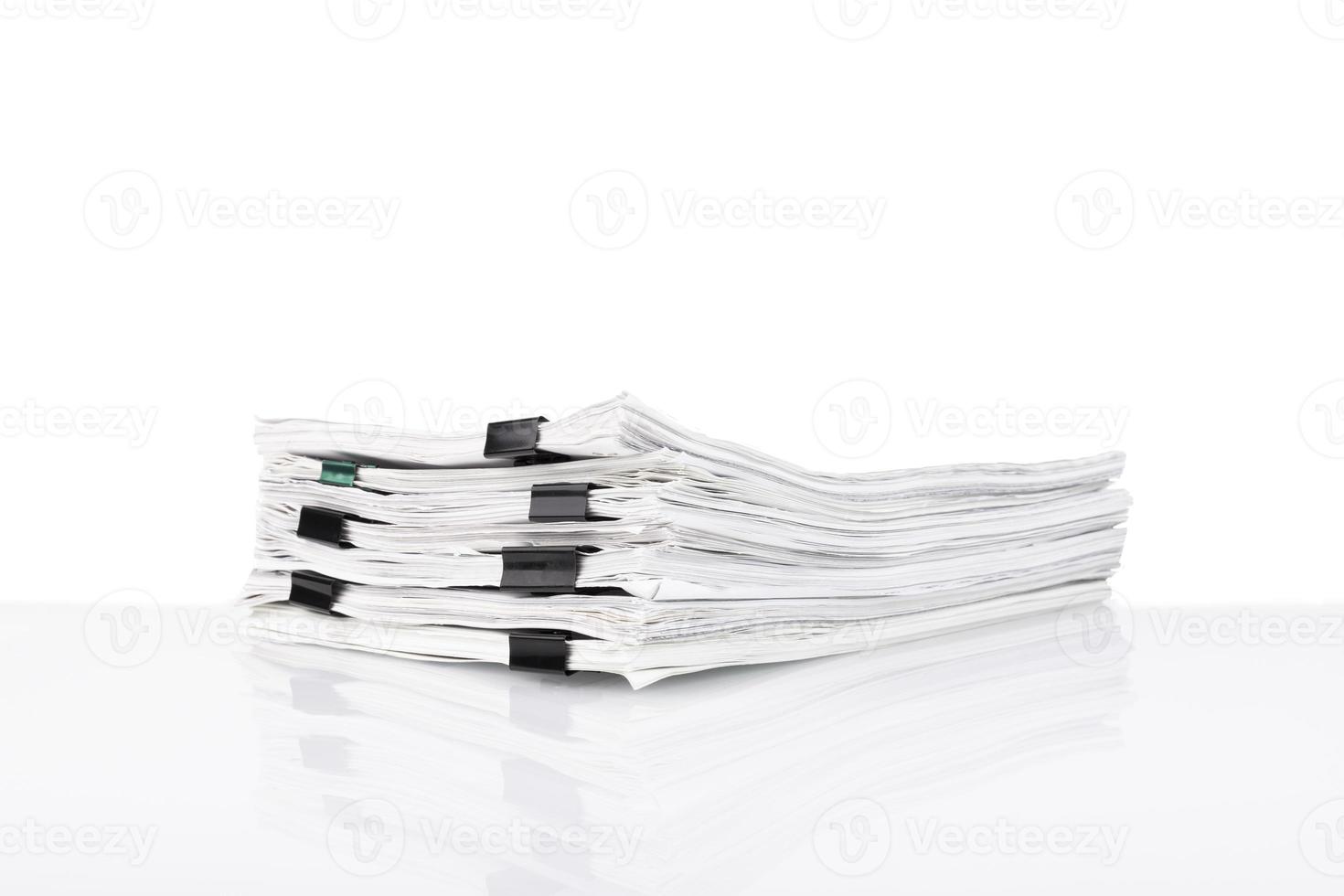 A stack of papers in the office on a white table, White isolated background. photo