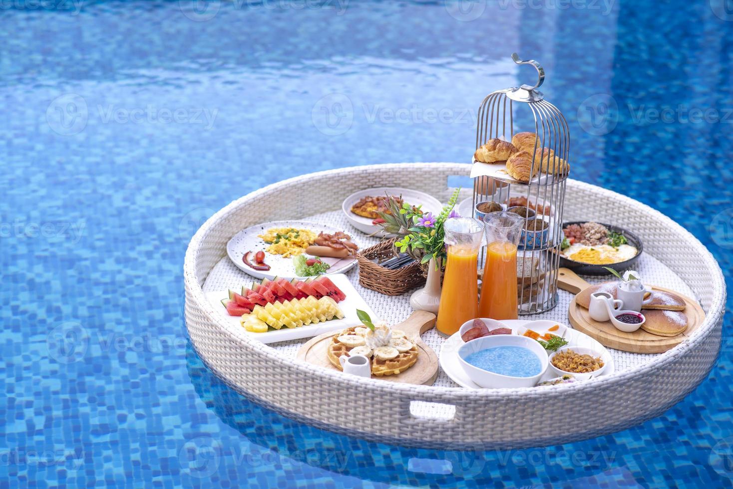 Breakfast in swimming pool, floating breakfast in villa resort. relaxing in calm pool water, healthy breakfast and tropical fruit. photo