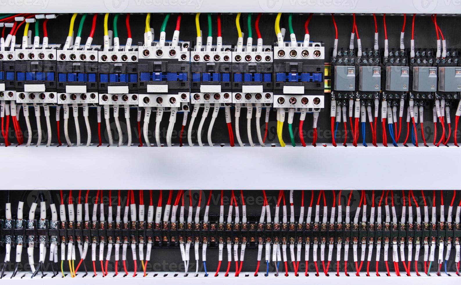 Close up circuit breakers and wire in control panel photo