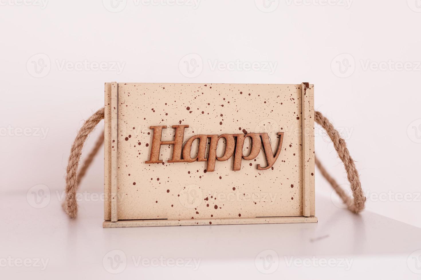 Happy word written on wood plate. Happy text on wooden table for your design on white table background. home decor. Close up photo