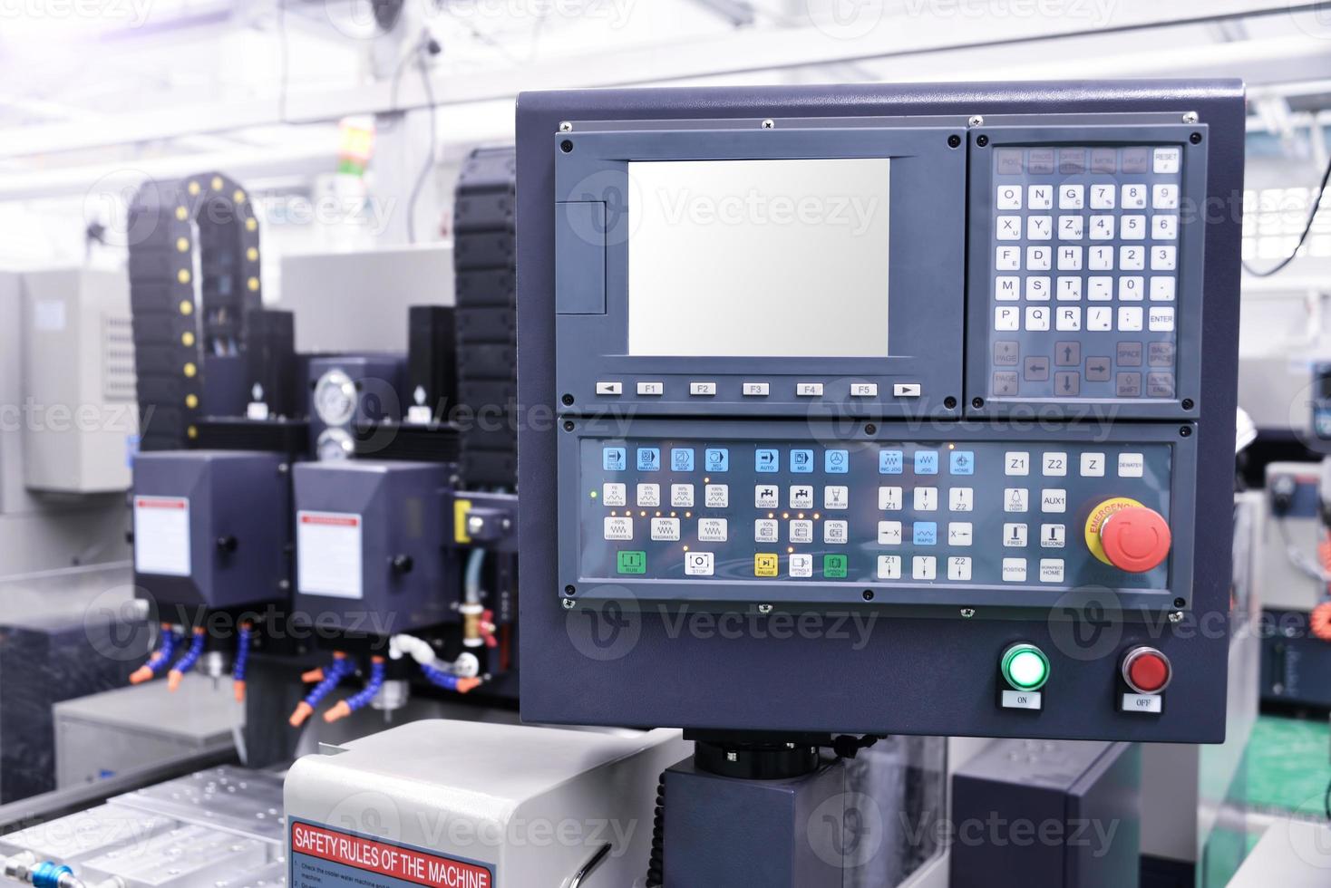 CNC machine with controller console in factory photo